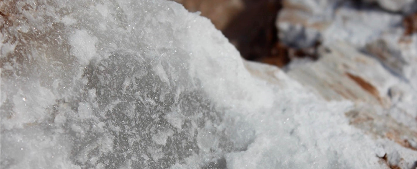 Raw Spanish alabaster stone showing natural translucent texture used in luxury decorative lighting.