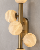 Close-up of Alabaster Alba wall light with Spanish alabaster globes and brushed brass framework