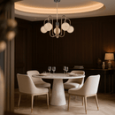 Alabaster chandelier illuminating elegant dining room with marble table and soft light.