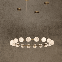 Luxury circular alabaster chandelier with 18 glowing spheres suspended from brass canopy.