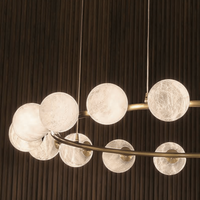 Cluster of illuminated alabaster spheres on the Galaxia ring chandelier.