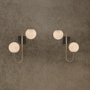 Luxury alabaster wall lamps in pair with warm glowing alabaster spheres and brass frame
