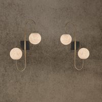 Luxury alabaster wall lamps in pair with warm glowing alabaster spheres and brass frame