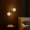 Bedside alabaster wall lamp creating warm ambient light in a modern bedroom