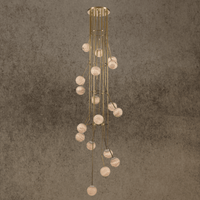 Tall cascading alabaster globe chandelier with brass frame for luxury staircases