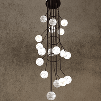 Brown-frame alabaster globe chandelier glowing softly in modern stairwell