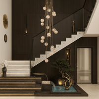 Large alabaster chandelier above staircase and indoor water feature in luxury villa