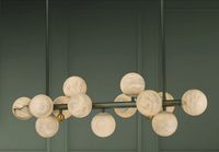 Close-up of the Alabaster Volta chandelier showing hand-carved alabaster globes.
