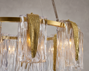 Aurora Sublime close-up showcasing artisan glass panels and textured brass detailing in a luxury chandelier