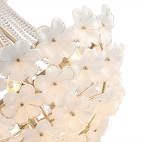 Detailed shot of hand-blown white glass flowers on the Camellia Bloom chandelier.