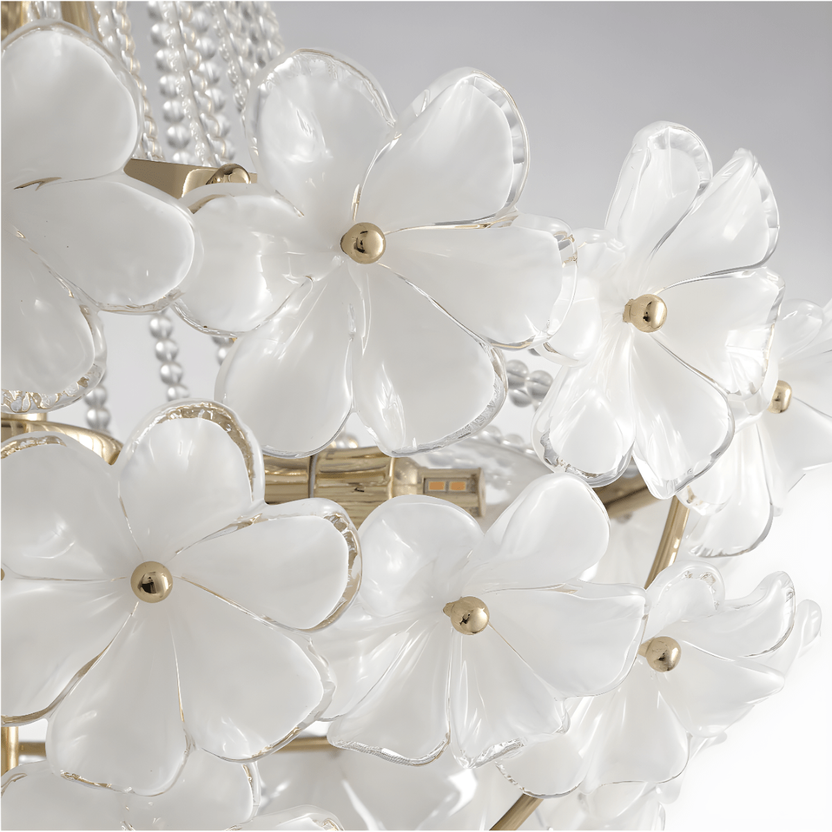 White Murano-style glass petals mounted on the gold frame of the chandelier.