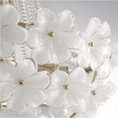 White Murano-style glass petals mounted on the gold frame of the chandelier.