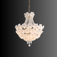 Smaller Camellia Bloom chandelier featuring white floral glass and gold metal frame.