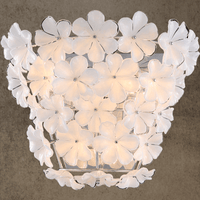 Luxury wall sconce with white Murano-style glass flowers on stainless steel frame by HDLS Lighting.