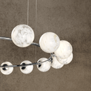 Galaxia chandelier in polished chrome finish with glowing alabaster spheres.