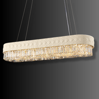 Angled view of Florence Trapunto Neve ivory leather and crystal linear chandelier