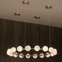 Brass ceiling canopies supporting the suspended Galaxia alabaster ring chandelier.