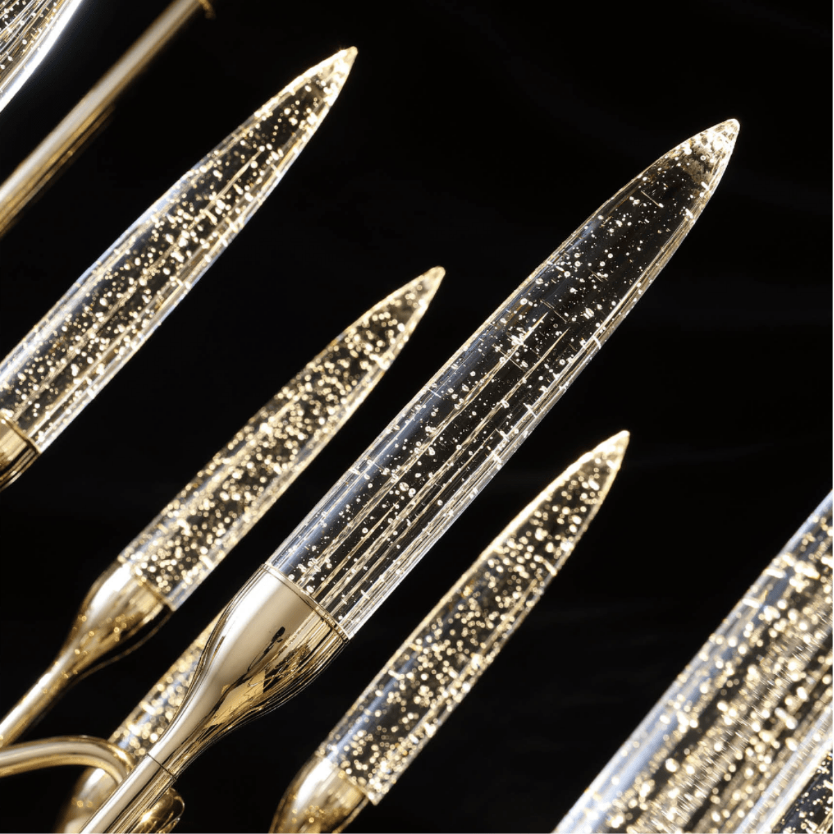 Angled view of handcrafted champagne crystal spires and 18K gold-plated arms from the Luce di Roma Theia.