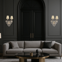 Elegant designer wall lights mounted beside arched doors in a sophisticated living room setting