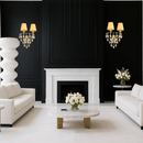Pair of gold Murano-style sconces flanking a modern fireplace in luxury black-and-white interior