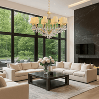 Gold and ivory chandelier featured in contemporary living room with marble and large windows.