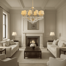 Elegant gold chandelier illuminating a refined beige living room with marble and soft lighting.