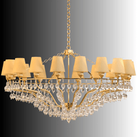 A large designer gold chandelier with Murano-style accents on a gradient background