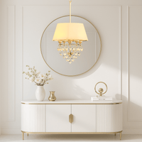 Boutique pendant chandelier with ivory shade and glass drops above console table in luxury dressing area