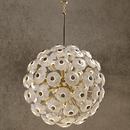 Large Modernus Moon chandelier with hand-textured Murano-style glass discs on a gold frame against a warm stone backdrop.