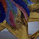 Detailed close-up of Swarovski crystals and gold leaf mosaic on AHURA lion sculpture