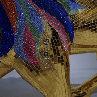 Detailed close-up of Swarovski crystals and gold leaf mosaic on AHURA lion sculpture