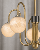 Close-up of Alabaster Aria chandelier with Spanish alabaster globes and brushed brass detailing by HDLS Lighting