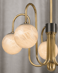 Close-up of Alabaster Aria chandelier with Spanish alabaster globes and brushed brass detailing by HDLS Lighting