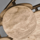 Close-up of hand-carved Spanish alabaster sphere showing natural veining and translucency.