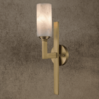 An architectural alabaster wall light in matt brass with solid copper frame and vertical spine design.