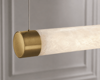 Luxury Spanish alabaster linear pendant with brushed brass end caps, architectural kitchen island lighting detail