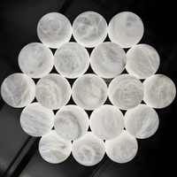 Close-up of illuminated Spanish natural alabaster spheres forming chandelier cluster.