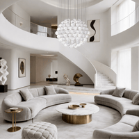 Large alabaster chandelier installed in double-height luxury foyer interior.