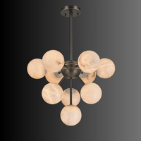 Alabaster Nova chandelier shown on dark gradient background highlighting natural stone veining.