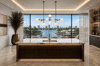 Alabaster Orbis linear alabaster chandelier above marble island in luxury waterfront kitchen