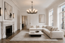 Alabaster Strata Chandelier installed in luxurious living room with white sofas, marble fireplace, wood floor in London Chesea