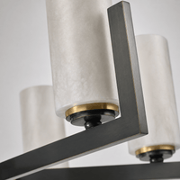 Close-up of honed Spanish alabaster cylinder mounted on copper arm showing natural stone texture.