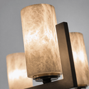 Close-up of illuminated Spanish alabaster cylinder showing natural veining and warm light diffusion.