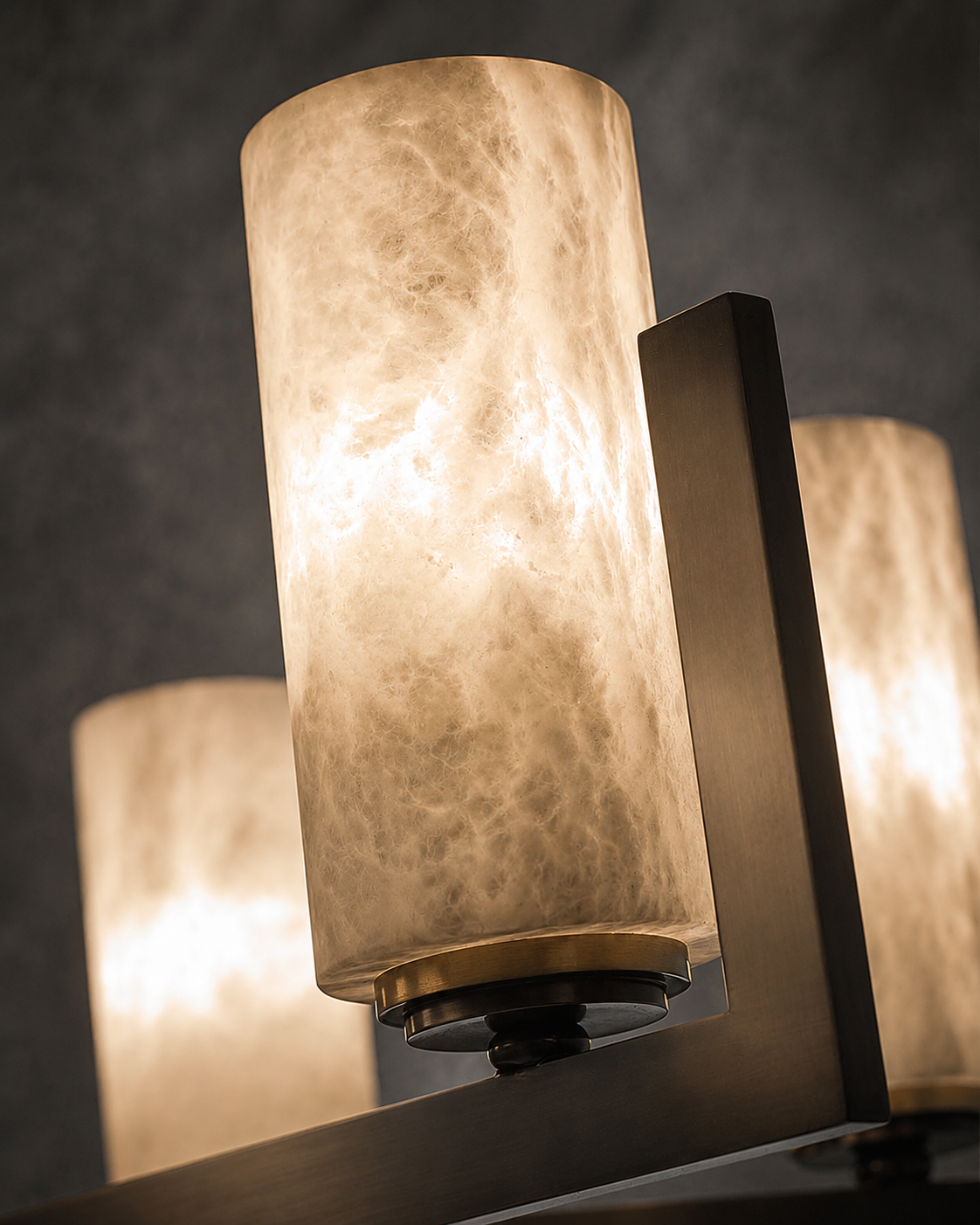 Close-up of illuminated Spanish alabaster cylinder showing natural veining and warm light diffusion.