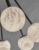 Close-up of a hand-shaped Spanish alabaster globe, revealing natural veining and soft translucency.