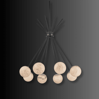 Luxury alabaster pendant light showcasing softly illuminated stone globes and architectural brass arms.