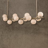 Alabaster Verta linear pendant with thirteen Spanish alabaster globes and antique brass structure