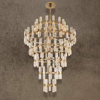 Large tiered crystal chandelier in gold with cascading crystal prisms designed for grand foyers and high ceilings.