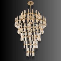 Luxury tiered crystal chandelier with gold frame and cascading crystals, ideal for grand foyer and staircase lighting.