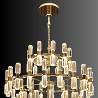 Close-up of gold tiered chandelier structure with faceted crystal prisms and integrated LED lighting.